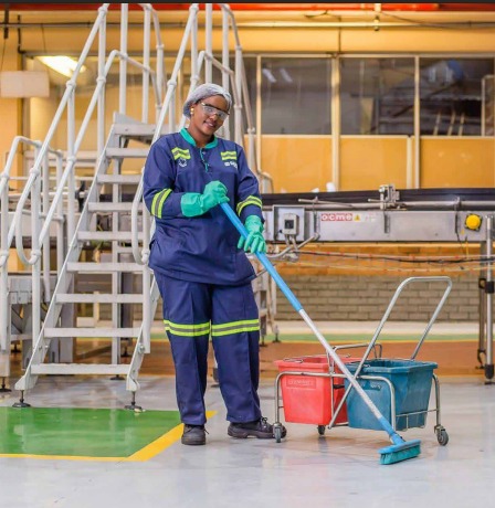 Lamar cleaner mopping the floor of a factory facility